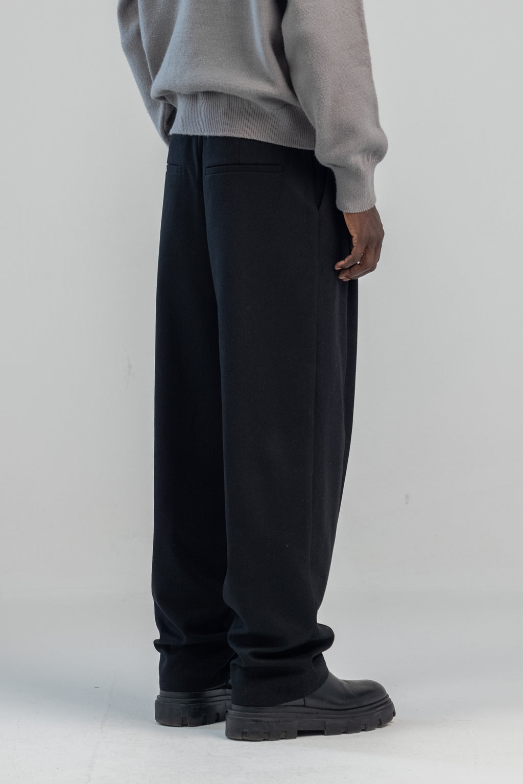 Black wool wide leg pleated trousers