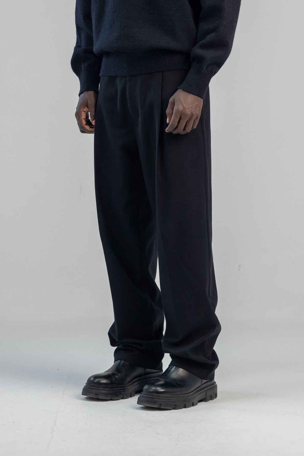 Black wool wide leg pleated trousers